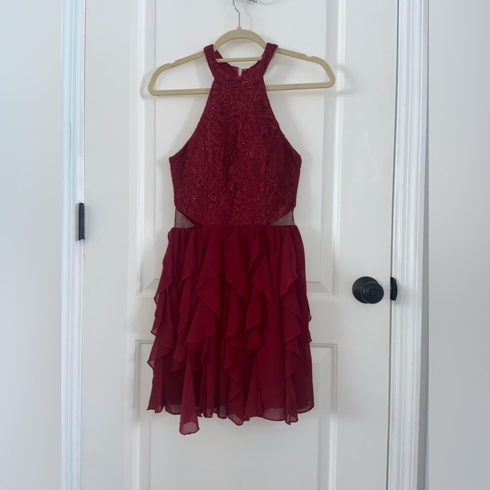 A beautiful formal dress.Mid thigh,halter top, floral design,cuts on each side.